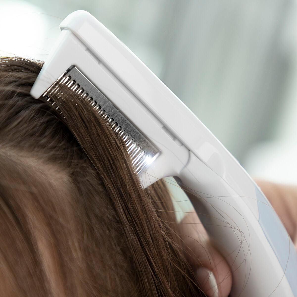 Electric lice comb with ergonomic handle gently removes lice while ensuring comfortable use for personal care.