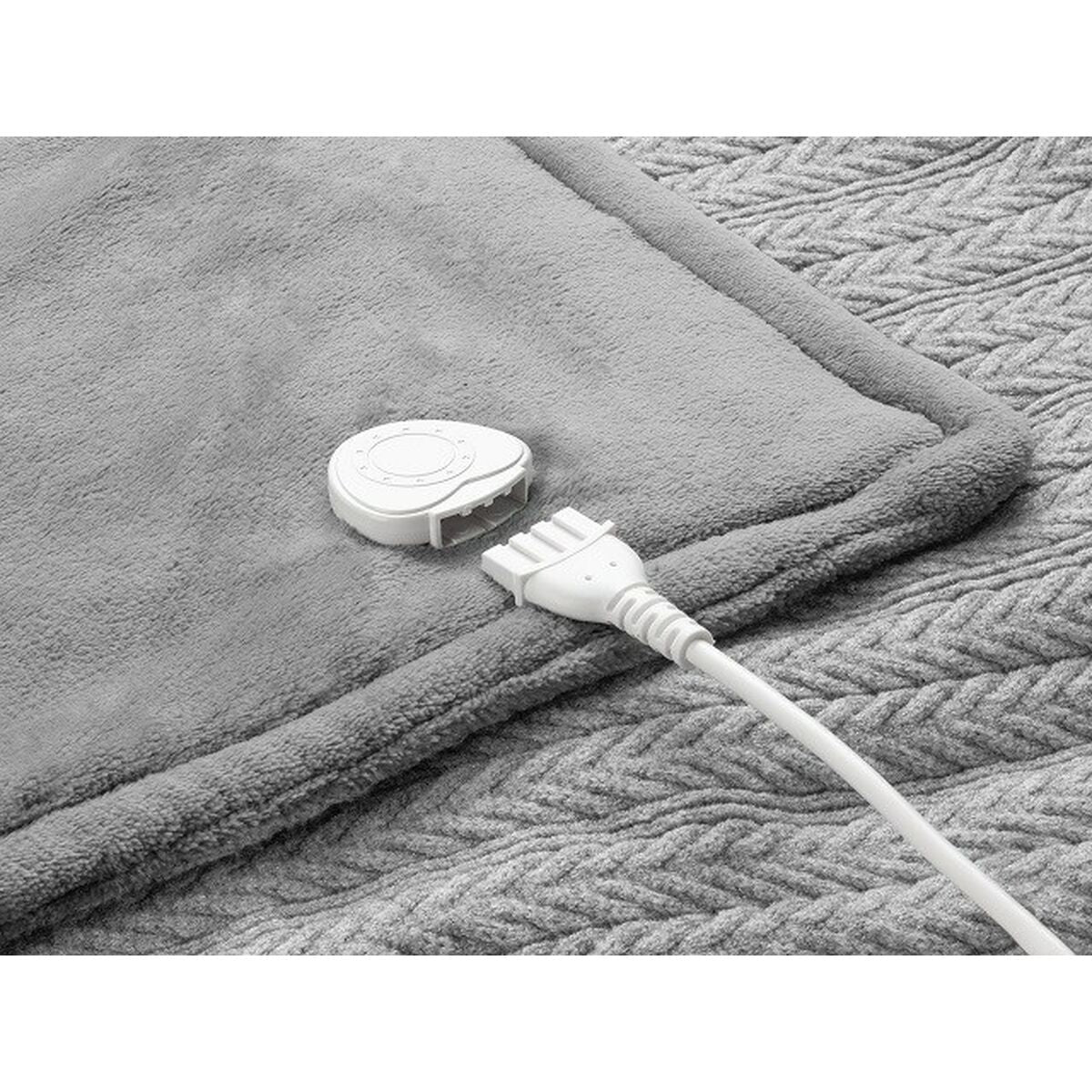 Manta eléctrica Medisana gris con control y cable visible, ideal para calentar el hogar.