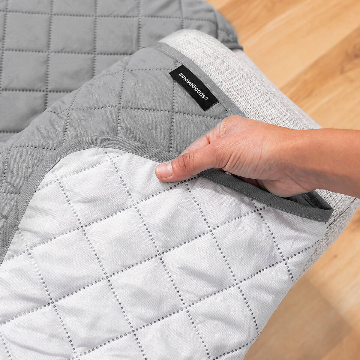 Reversible sofa protector cover in grey, showcasing modern design and quilted texture for 3-seater sofas.